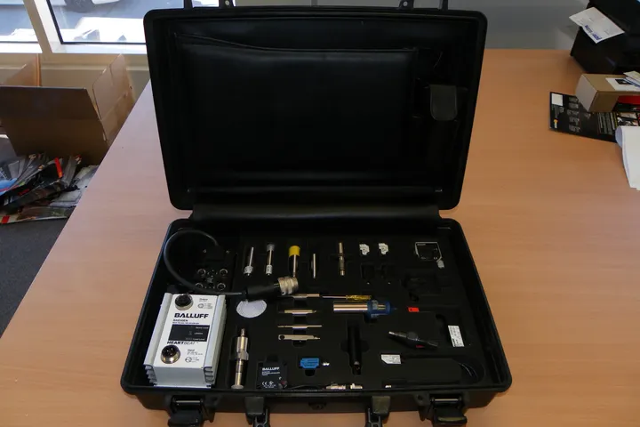 Custom foam insert for automotive sensor test equipment in a black briefcase